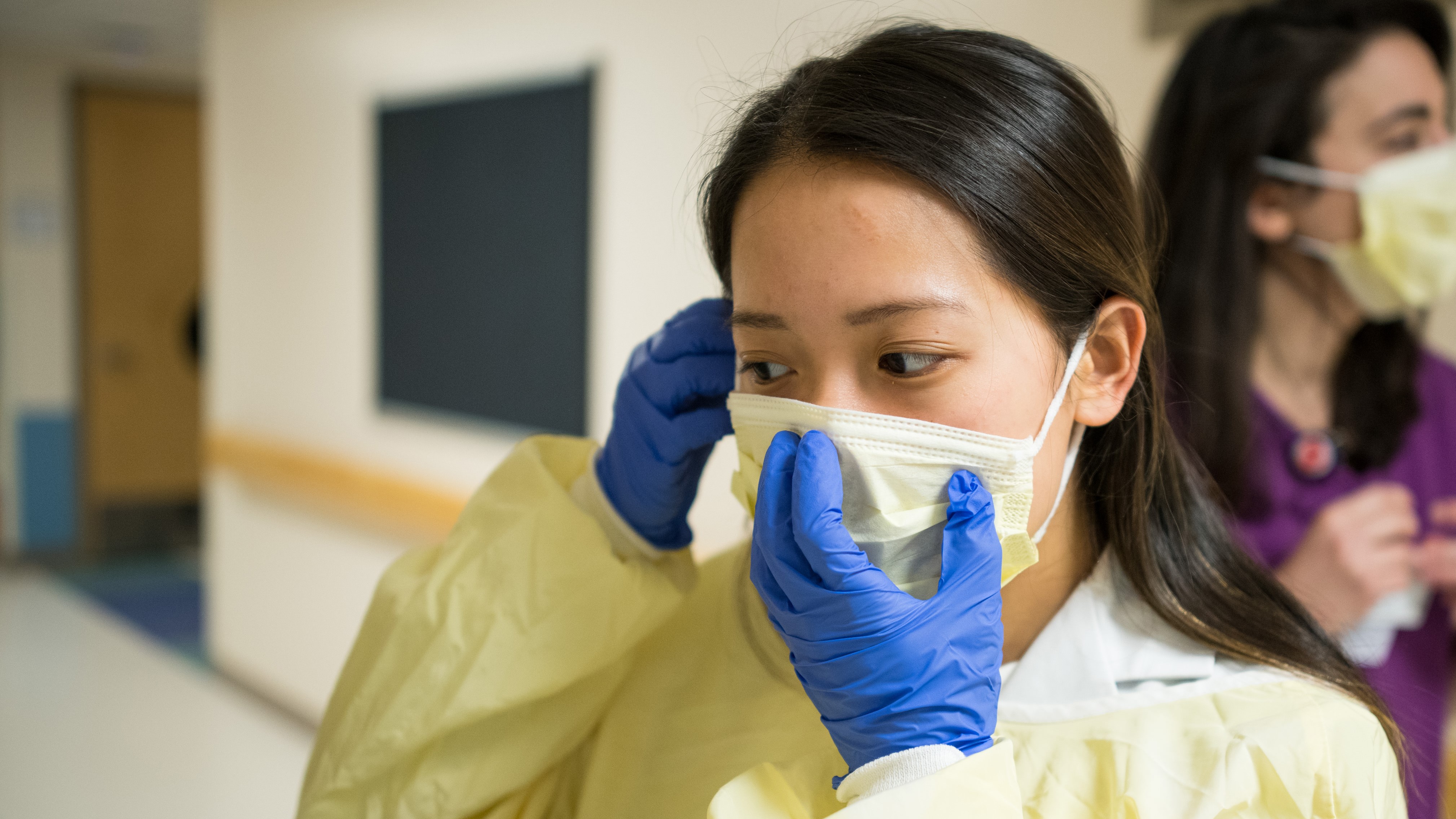 A nurse wearing medical wearing personal protective equipment