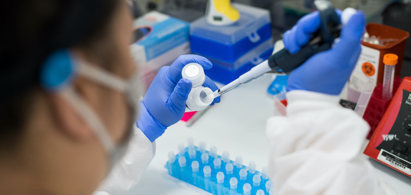 Close up of a lab technition processing vaccine results