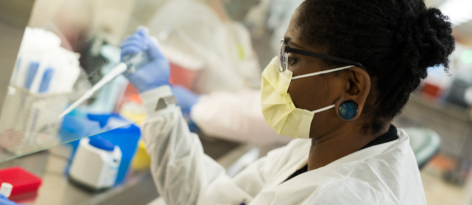 Candid of Infectious Disease staff member working in UVM Medical Center lab.