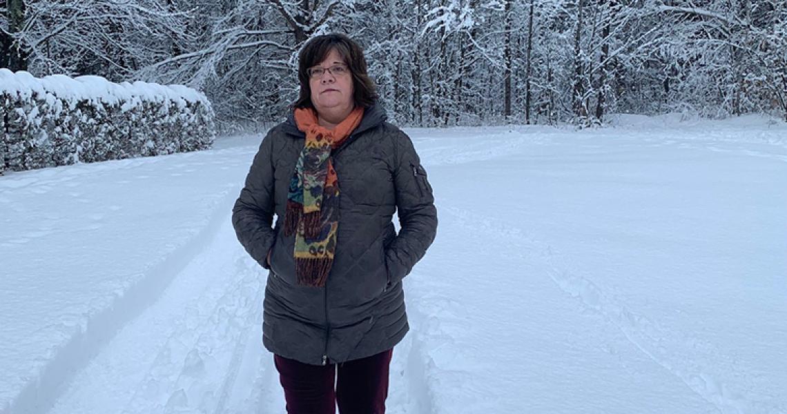 Woman walking outside inside the snow.