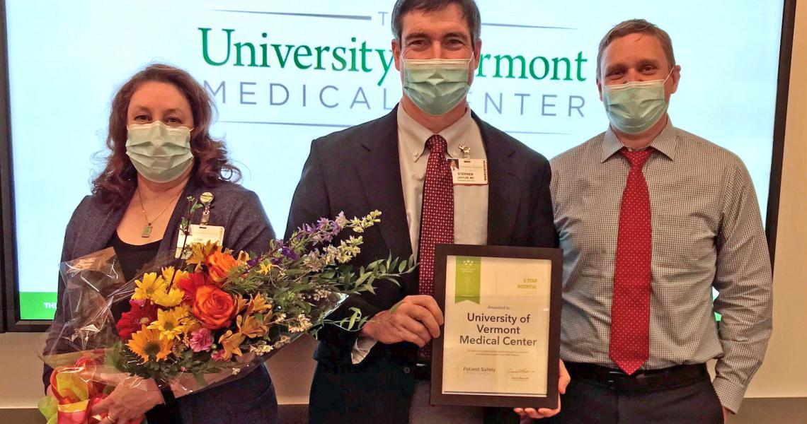 Dr. Leffler, standing with two staff members, of UVM Medical Center holding the 5 Star Award for Patient Safety.