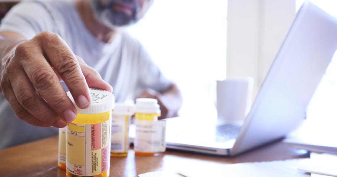 Man examines prescriptions