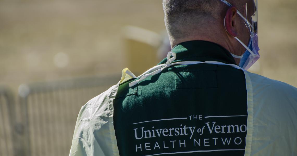 UVM Health Network employee in PPE conducting COVID testing