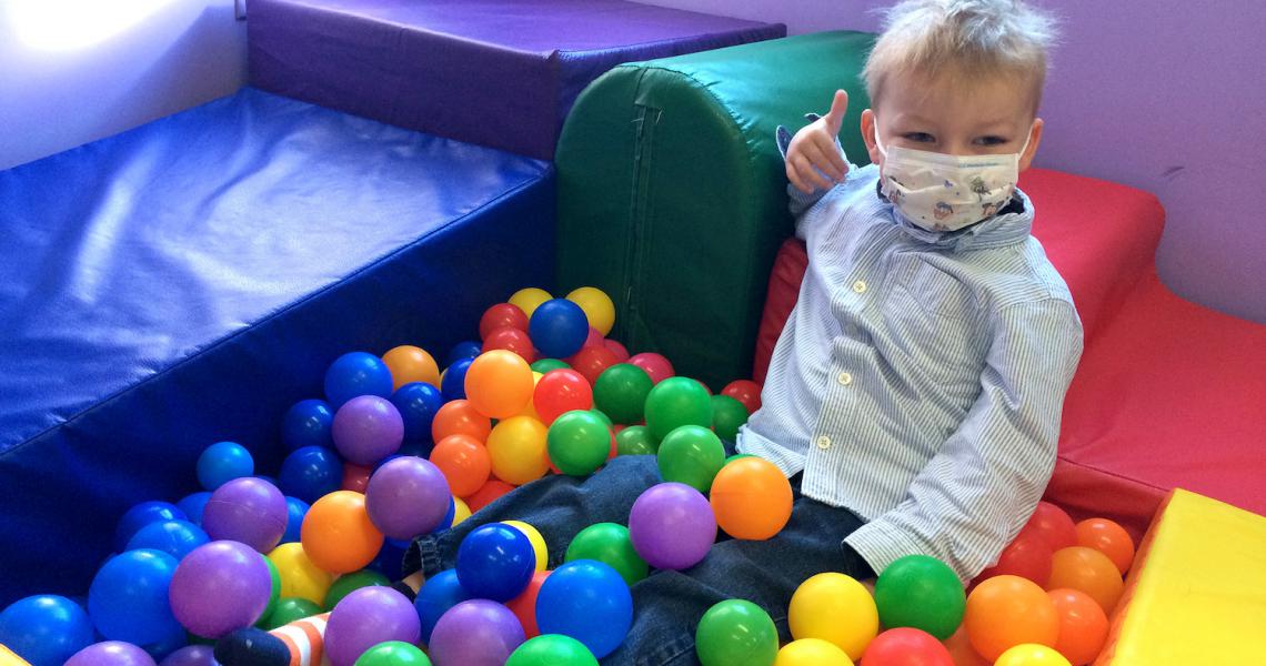 Toni Josey sitting in ball pit at UVM Medical Center. 