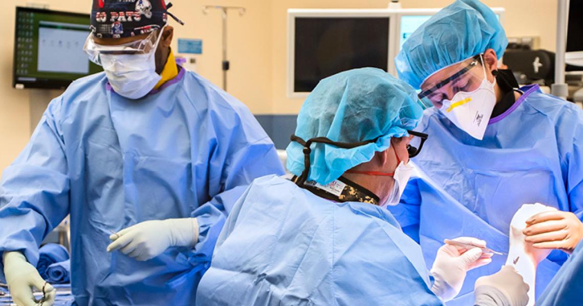 Surgeons operating on a wrist