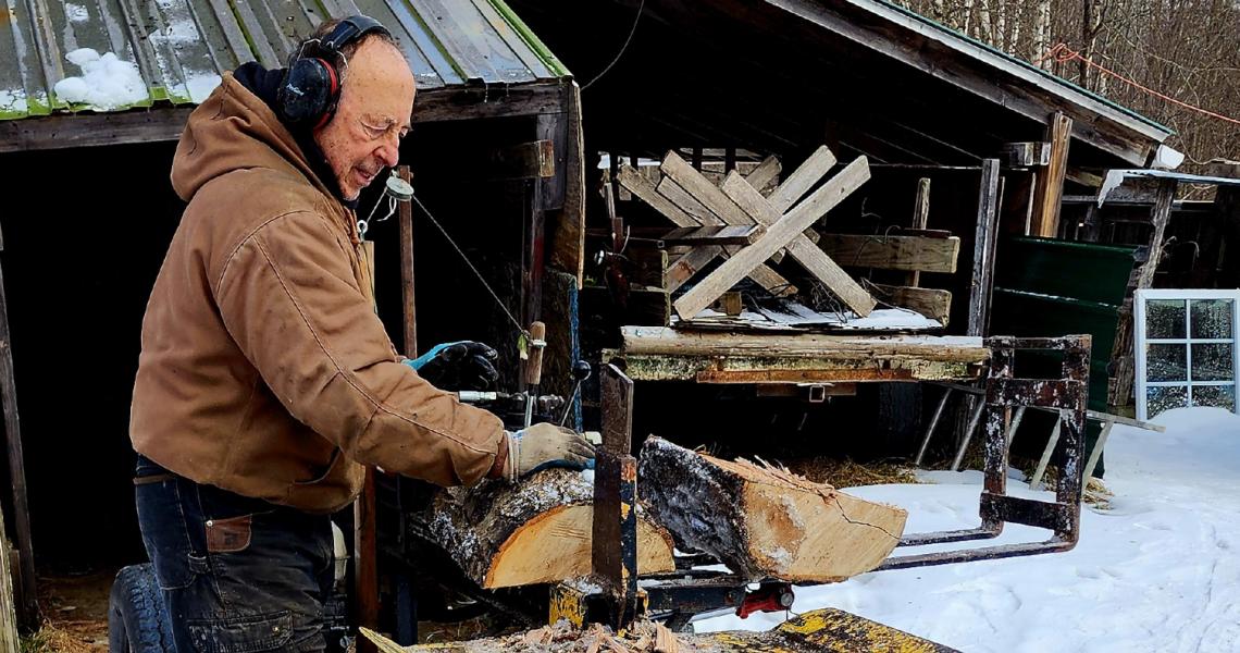 TAVR patient Varney splits and cuts wood at his home