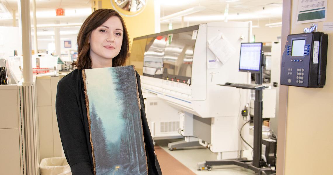 Riley Rock-Lavarnway poses at CVPH with one her paintings.