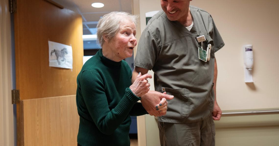 CVPH Skilled Nursing Facility (SNF) provider walks with patient.