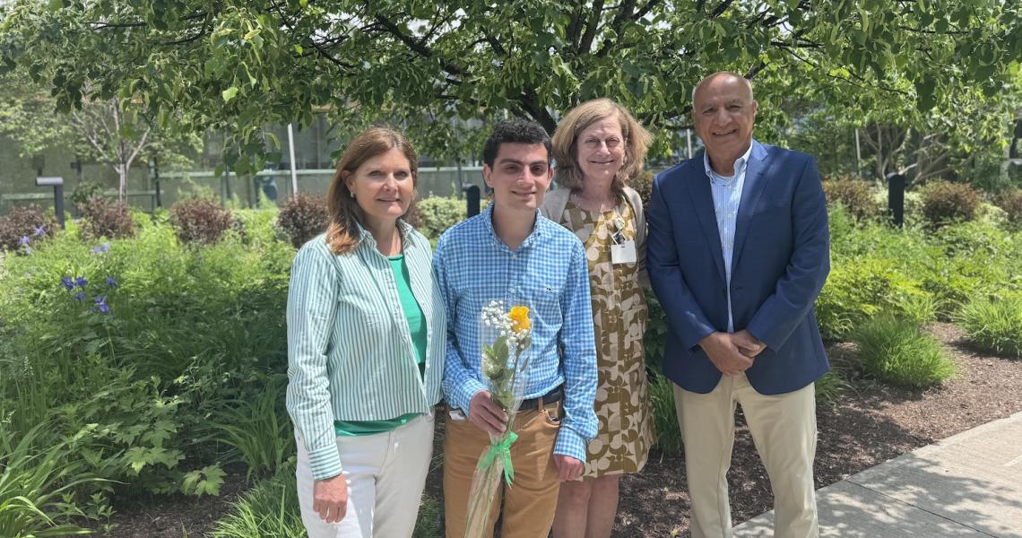 Bijan Salimi poses with family and Jill Bowen, PhD, outdoors at Project SEARCH ceremony at UVM Medical Center.