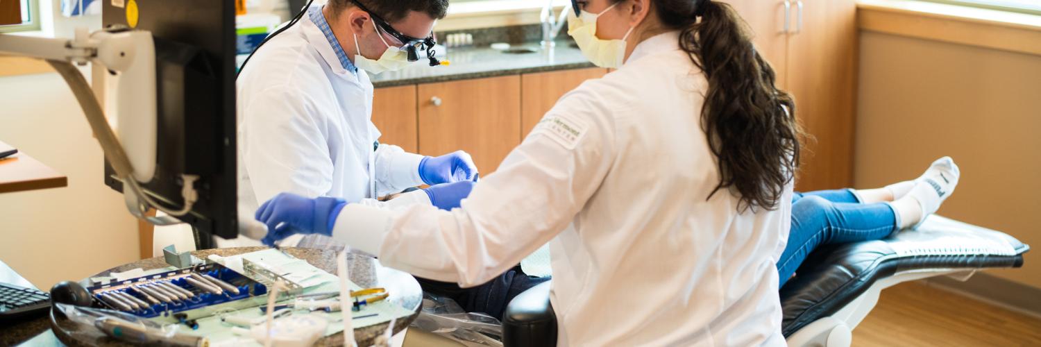UVM Medical Center dental team cleaning patient's teeth.