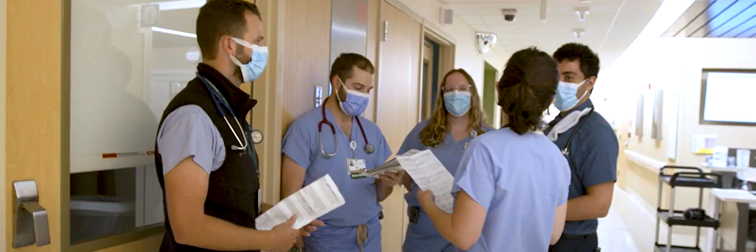 UVMMC Internal Medicine residents in conversation in the hallway.