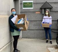 Larner School of Medicine students holding boxes of PPE donations