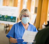 Patient being screened for Covid-19 before entering facility