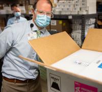 UVMMC Wes McMillian, Director of Pharmacy Services, verifies the successful delivery of the Pfizer COVID-19 vaccine