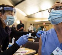 Health care provider giving vaccine to UVM Health Network employee