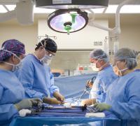 Group of medical professionals performing surgery in operating room