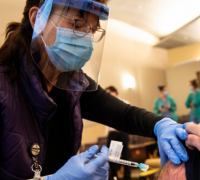 UVMHN employee vaccinating community member