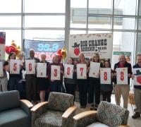 BCRU staff and volunteers hold numbers for fundraiser.