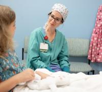 Nurse talking to youg patient in bed