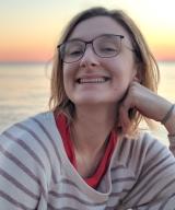 Portrait of Naomi Koliba, MD on the waterfront at sunset. 