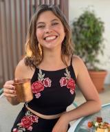 Stephanie Vistnes, MD smiling holding a copper mug.