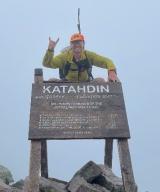 Daniel Moroney, MD poses at mountain summit. 