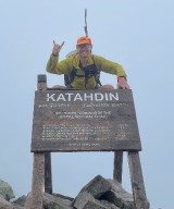 Daniel Moroney, MD poses at mountain summit. 