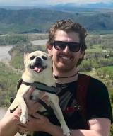 Loften Fansler, DO hiking with his dog in the summer. 