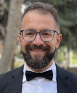 Portrait of Mohammad Mohaghegh MD outdoors wearing a tuxedo.