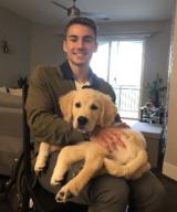 Jacob Catinella, DMD, holding his dog