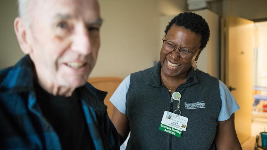 UVMMC Home Health and Hospice LNA smiling with patient.